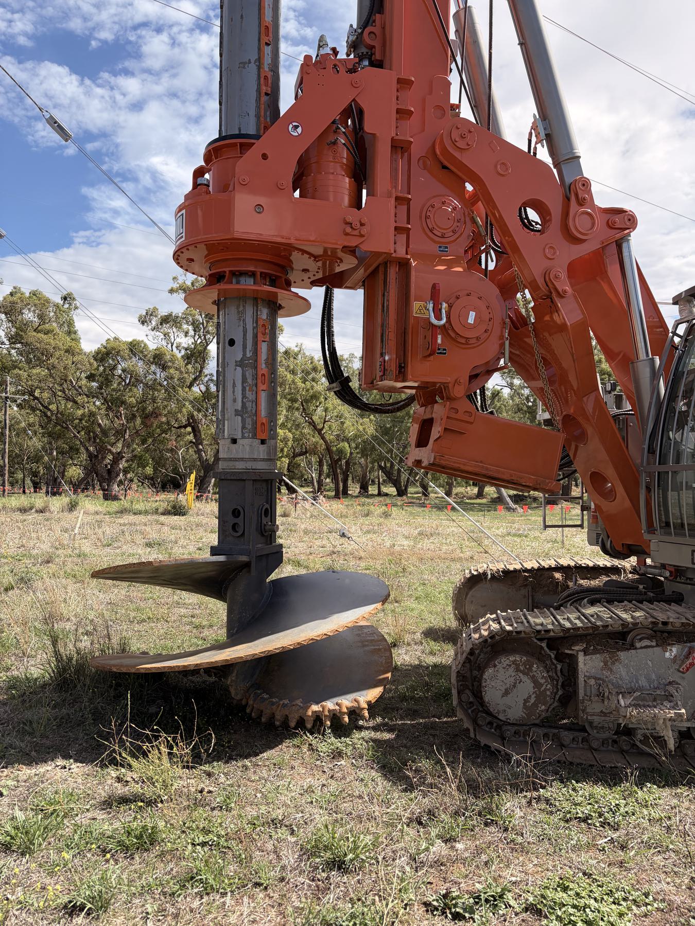 Close view of a piling tool engaging the ground