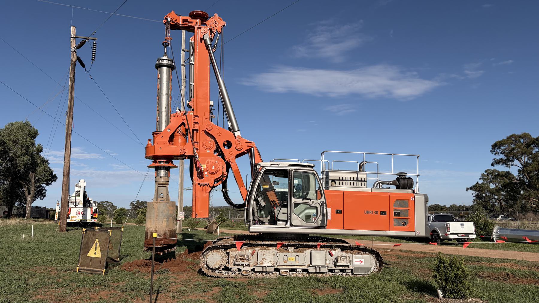 Specialist piling rig working in an open field
